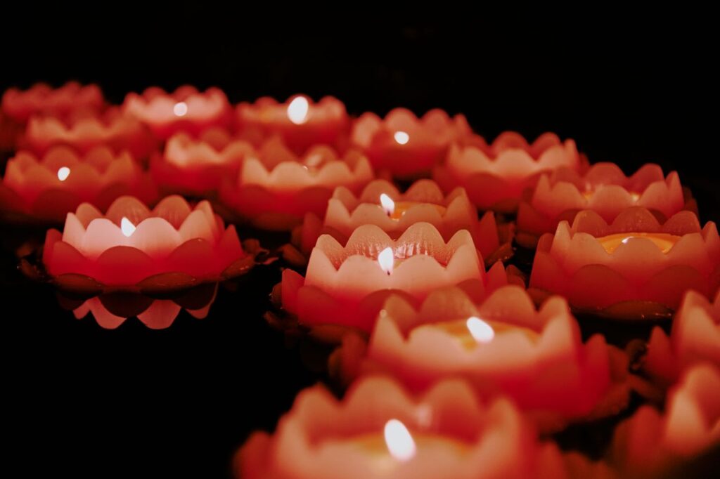 Serene arrangement of lotus flower candles creating a warm and tranquil ambiance.